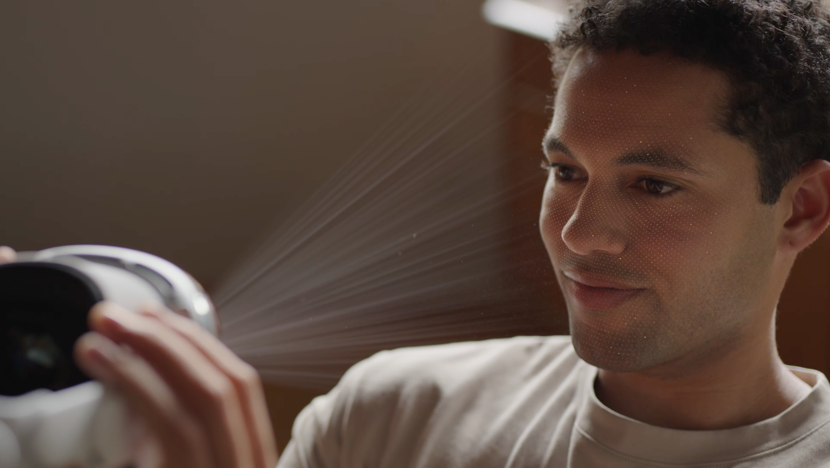 Person holding Apple Vision Pro toward their face during Persona enrollment